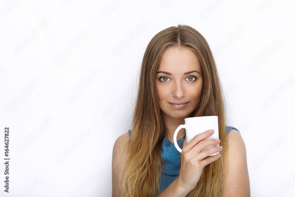 Headshot of young adorable playful blonde woman with cute smile in cobalt color blouse posing with big pure white mug on white backdrop Headshot of young adorable playful blonde woman with cute smile in cobalt color blouse posing with big pure white mug on white backdrop