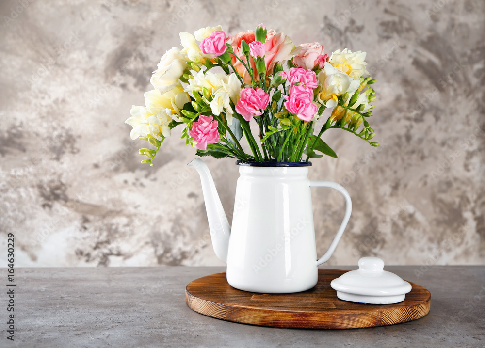 Beautiful bouquet of fresh freesia in vase on table Beautiful bouquet of fresh freesia in vase on table