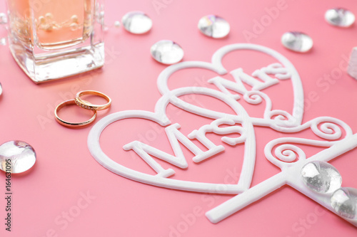 Beautiful composition with rings for lesbian wedding on color background