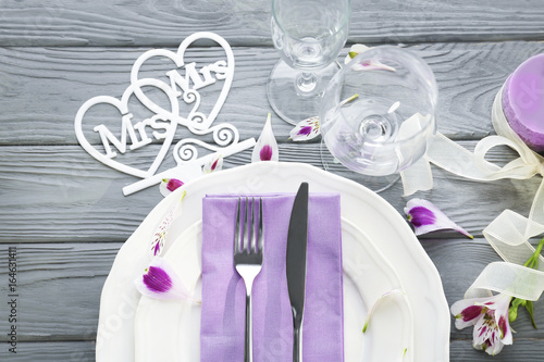Beautiful table setting for lesbian wedding on wooden background