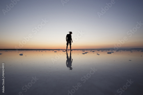 man standing sunset silhouette at salt lake