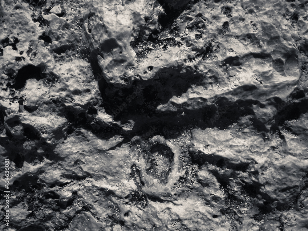 Naklejka premium Macro closeup on surface of the rock stone dark background