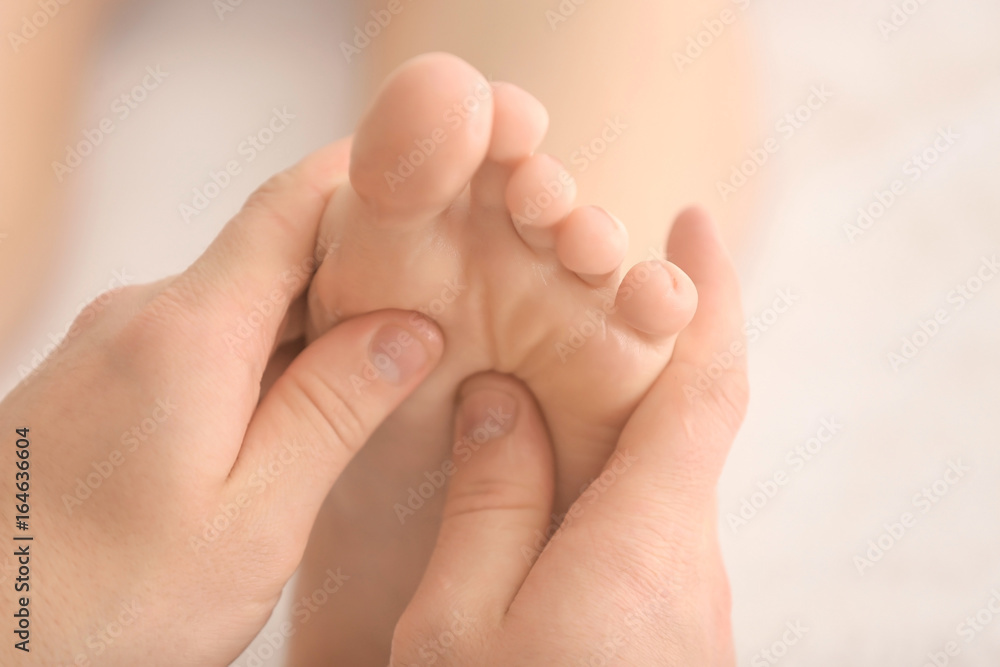 Young woman having foot massage in spa salon, closeup Young woman having foot massage in spa salon, closeup