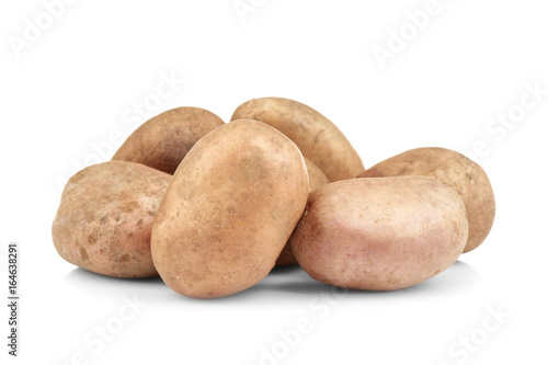 Raw unpeeled potatoes on white background