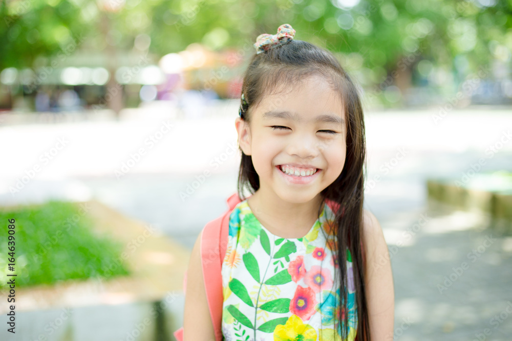 Happy asian girl arriving school from home with a backpack Happy asian girl arriving school from home with a backpack