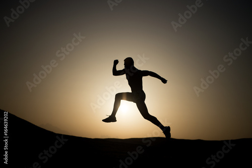 silhouette or man runner  guy running outdoor at clear sky