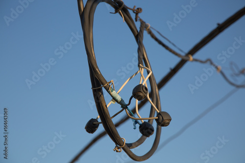 Electrical lines crossed blue sky photo