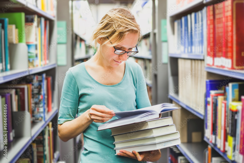 student girl in the library reading books, education concept student girl in the library reading books, education concept