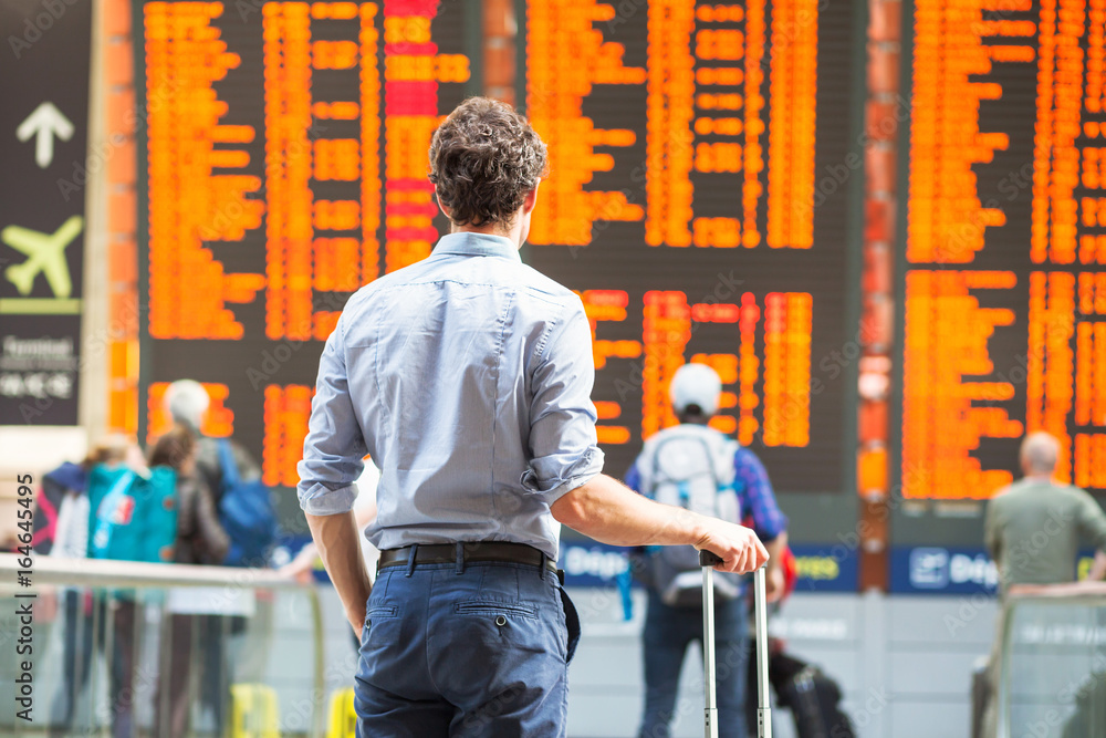 Ταπετσαρία delay of flight, people passengers waiting in airport and looking at electronic