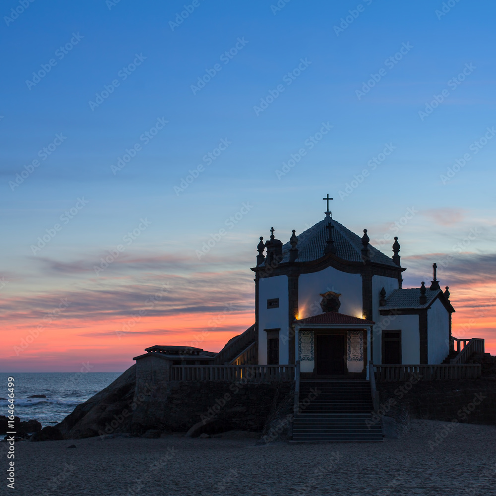 Chapel Senhor da Pedra at dusk, Miramar Beach, Portugal. Chapel Senhor da Pedra at dusk, Miramar Beach, Portugal.