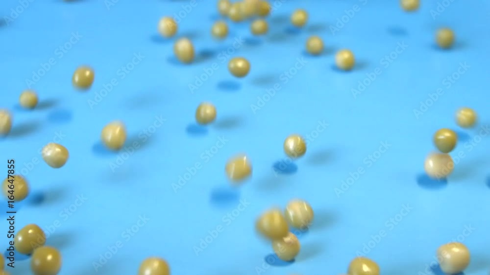 Canned green peas on a blue background. 2 Shots. Slow motion. Horizontal pan. Close-up.
Canned green peas are rolling down on a blue background. Canned green peas on a blue background. 2 Shots. Slow motion. Horizontal pan. Close-up.
Canned green peas are rolling down on a blue background.