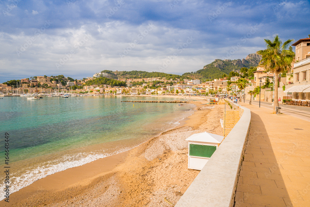 Puerto de Soller, Port of Mallorca island in balearic islands, Spain. Beautiful  beach and bay with boats in clear blue water of summer day.