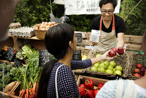 Greengrocer selling organic fresh agricultural product at farmer market