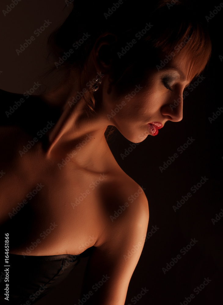 Lingerie model woman over dark background Lingerie model woman over dark background