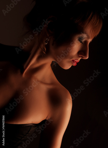 Lingerie model woman over dark background
