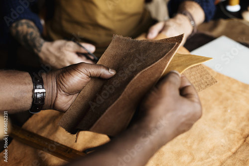 Εκτύπωση καμβά Closeup of craftsman holding leather handicraft