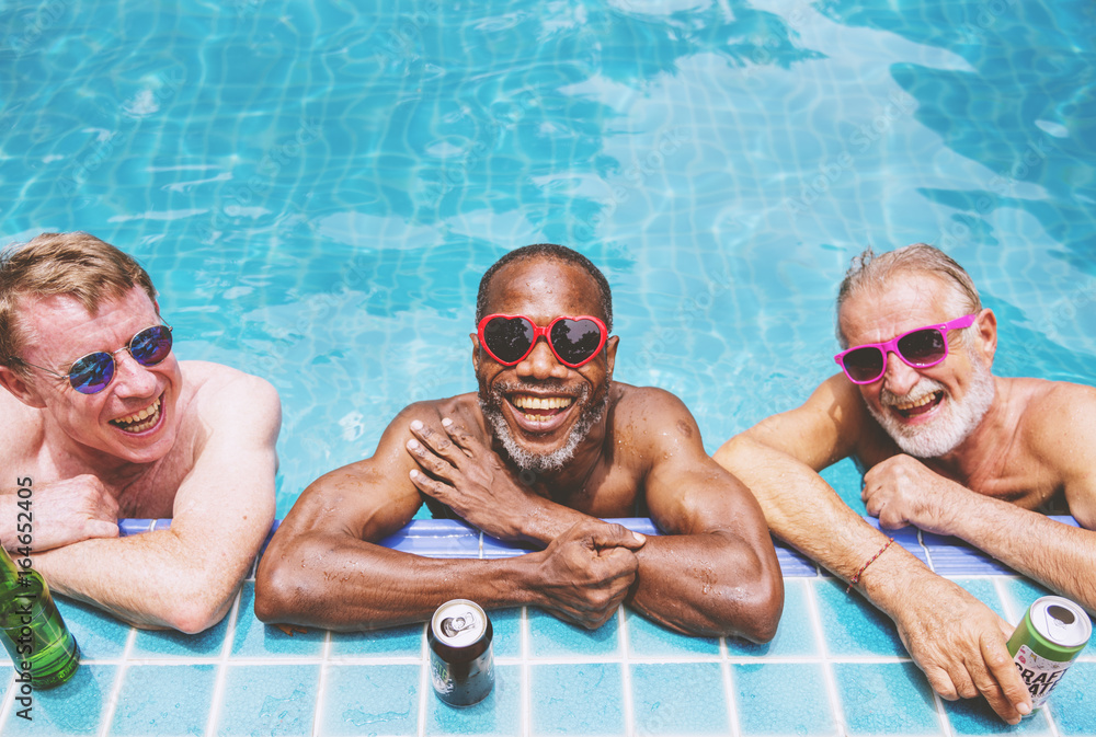 Group of diverse senior men enjoying the pool together