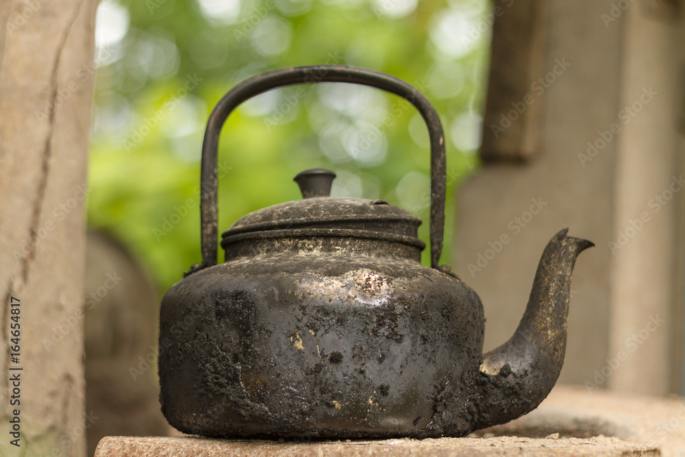 Old black kettle.Rubber plantation farmers will use black kettle to boil  coffee late at night to go out to cut rubber. Stock Photo | Adobe Stock