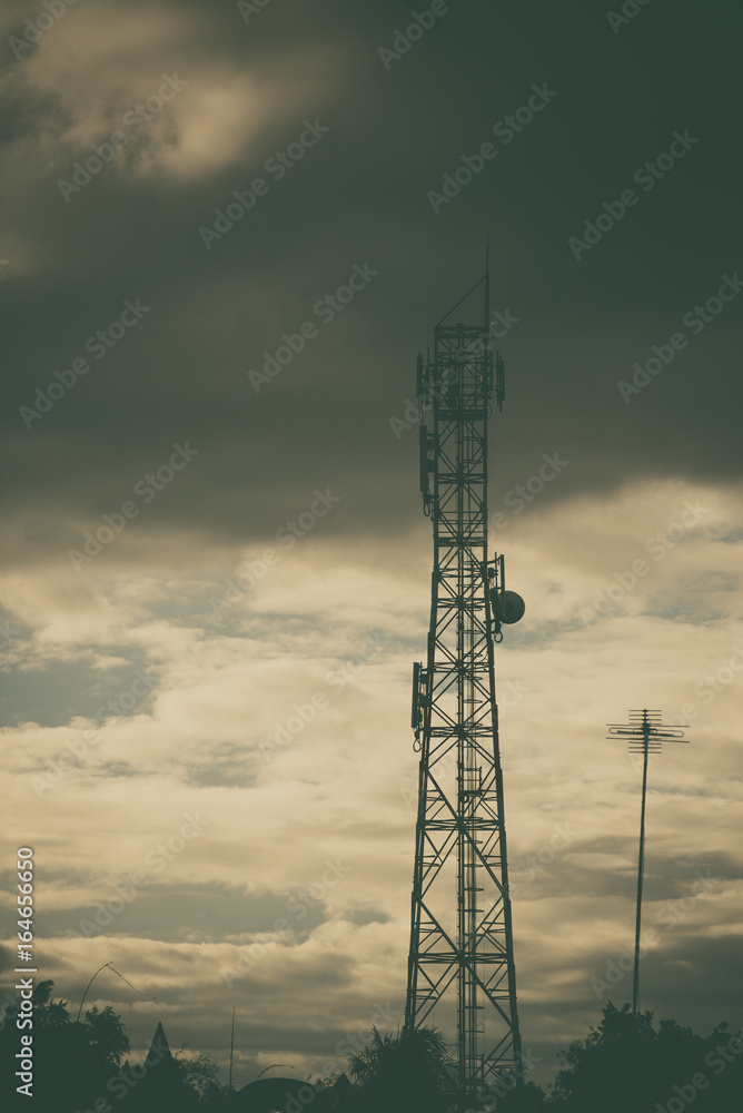 Antenna of cellular and communication system tower with the blue sky and cloud. vintage tone.