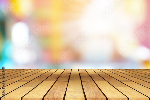 Perspective wooden table on top over blur coffee shop background  can be used mock up for montage products display or design layout.