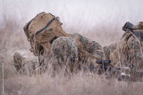 Soldiers from US Navy Amphibious Squadron 8 assault an enemy strong point during a NATO military exercise photo