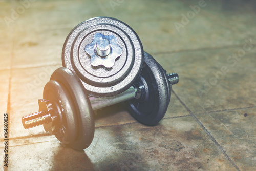 Twin Iron Dumbbells on the floor for home workout.