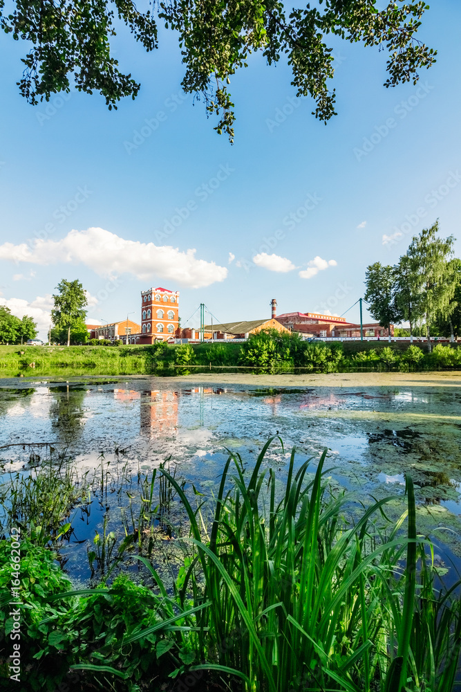 Beautiful scenery with a river and a factory on the shore Beautiful scenery with a river and a factory on the shore