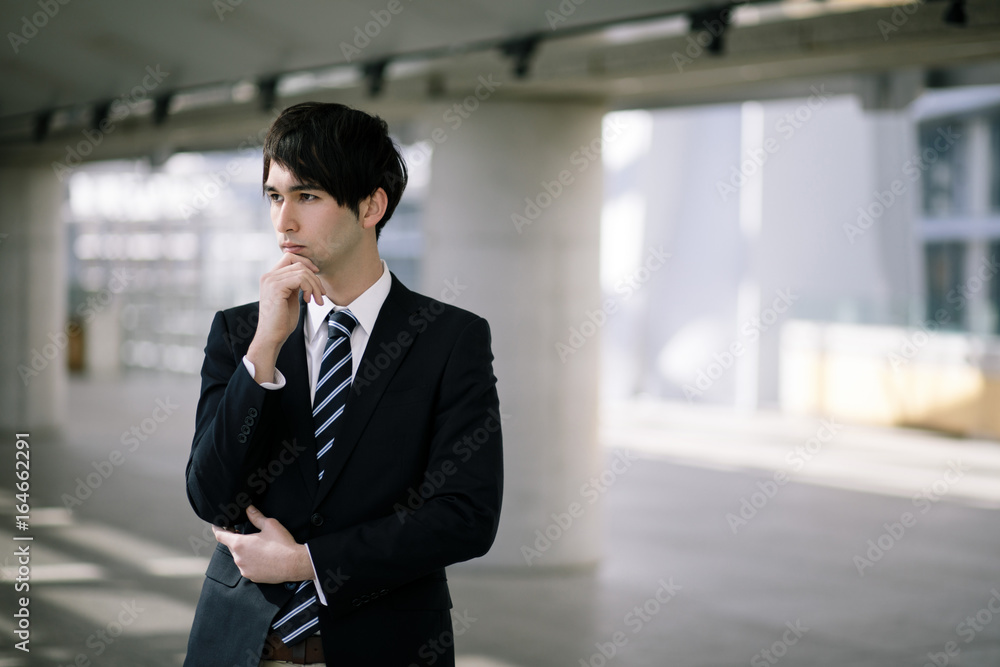 young businessman folding his arms. young businessman folding his arms.