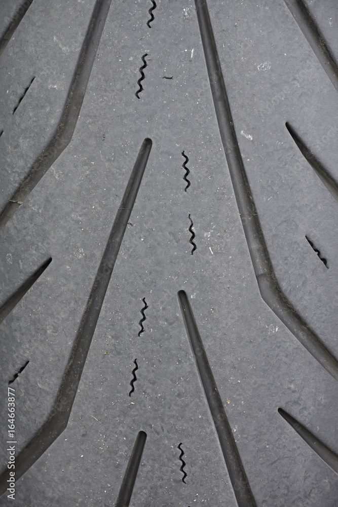 Fototapeta premium Motorcycle tyre treads are designed to give good wet grip but the road surface also plays a significant role in tyre to road adhesion