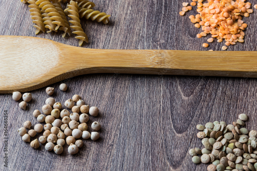 Legumes. Decorations of ingredients of red and dark lentils, chickpeas and wholegrain pasta Legumes. Decorations of ingredients of red and dark lentils, chickpeas and wholegrain pasta