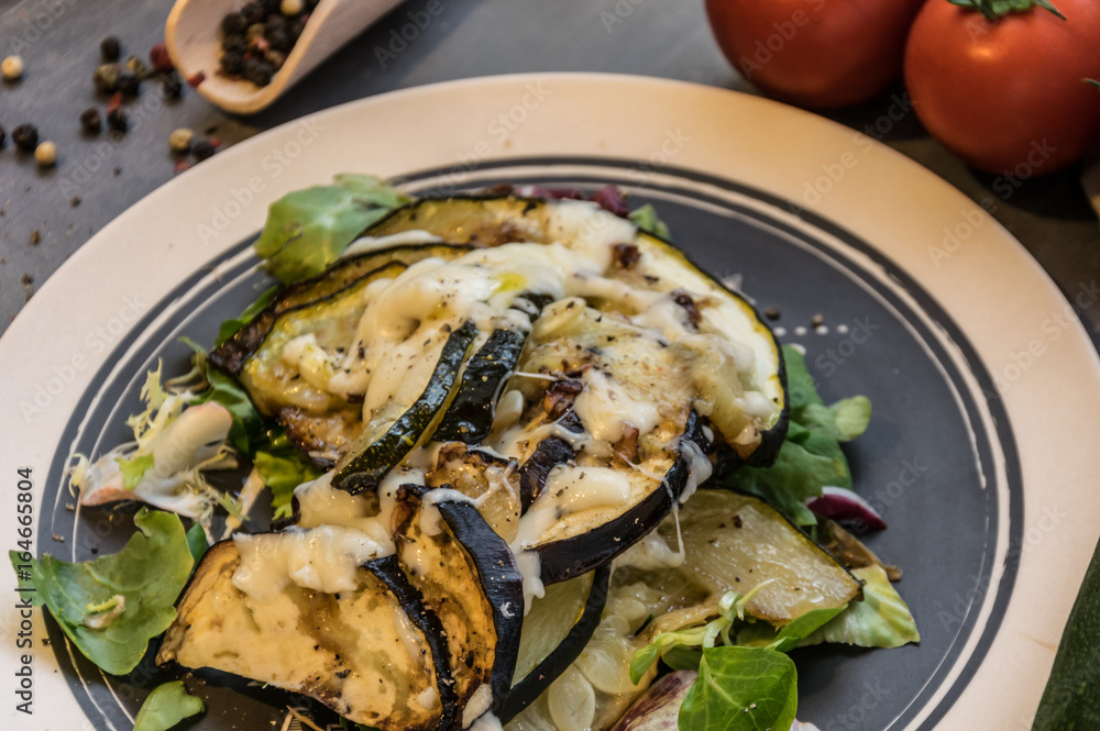 Baked zucchini and eggplant on ice salad sprinkled with cheese Baked zucchini and eggplant on ice salad sprinkled with cheese