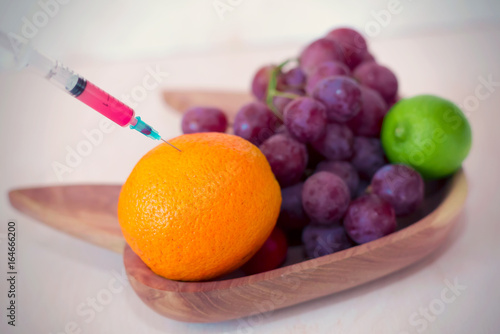 Syringe with grape and fruits injection