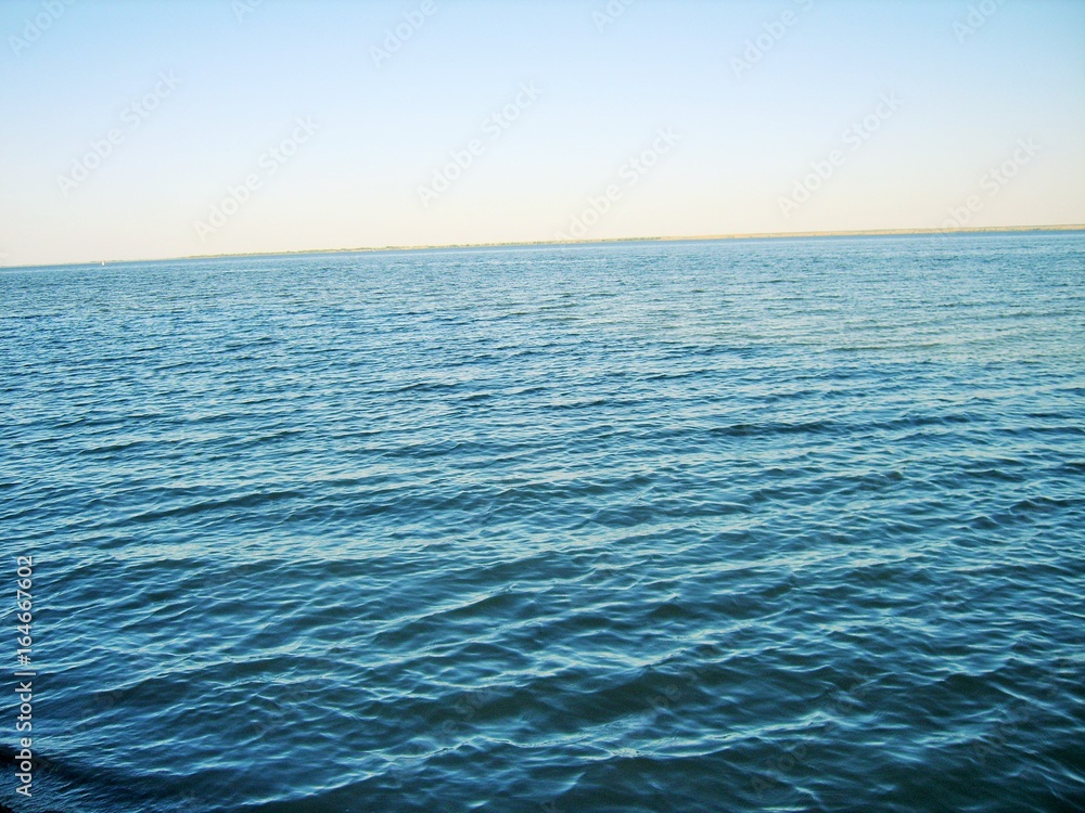 Fototapeta premium blue river and blue sky separated by a horizon line