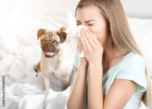 Canvas Print Young ill woman with tissue and pet on background