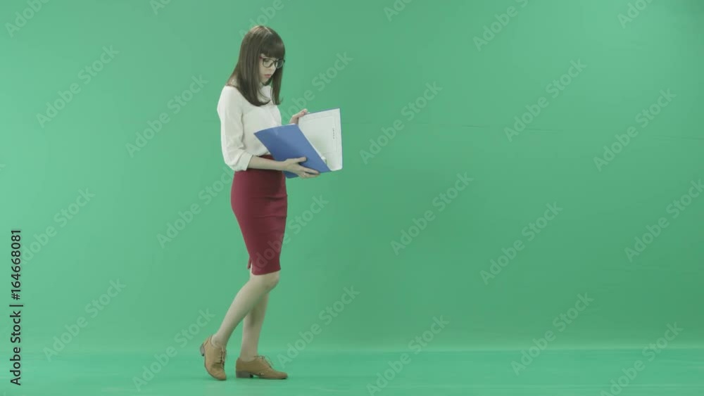 Beautiful girl walking with a blue folder Beautiful girl walking with a blue folder