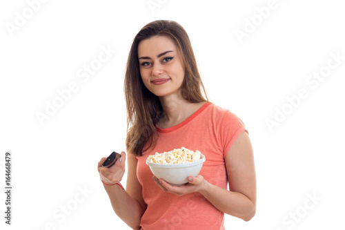 lovely young woman with tv remote and pop-corn watching movies