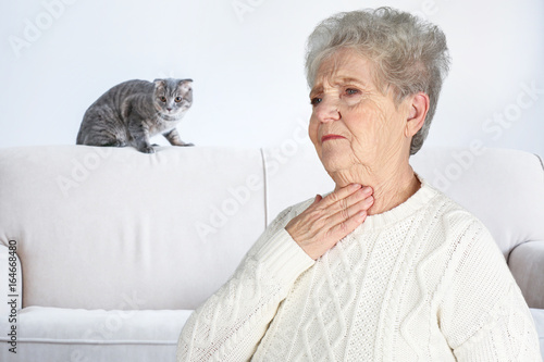 Senior ill woman with sore ...
