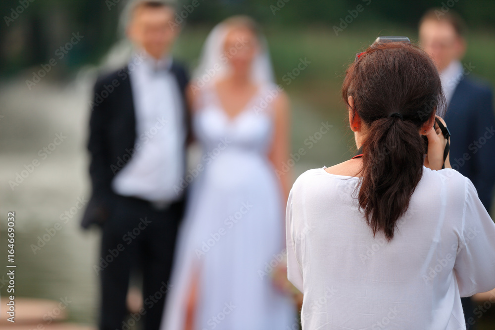 Photographer doing photo of young couple outdoors