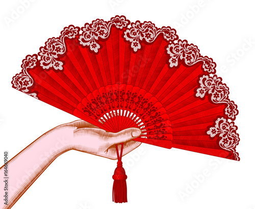 Female hand with red open fan