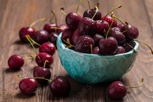 Cherries in a bowl with water drops 