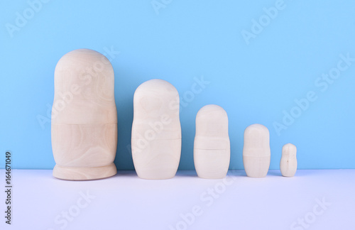 Photography Set of russian dolls on blue background.