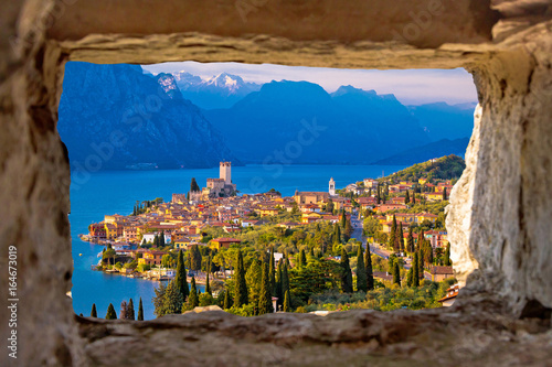Malcesine and Lago di Garda aerial view through stone window