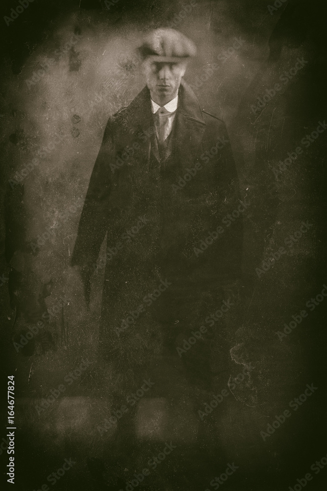 Fototapeta premium Antique wet plate photo of threatening 1920s english gangster holding gun in smoky room.