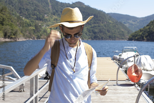 young man with backpack and map, people travel and vacation