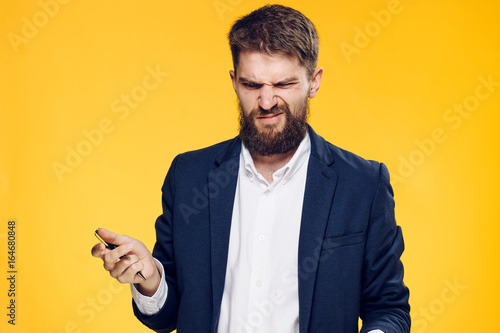 Business man with a beard on a yellow background, portrait © SHOTPRIME STUDIO