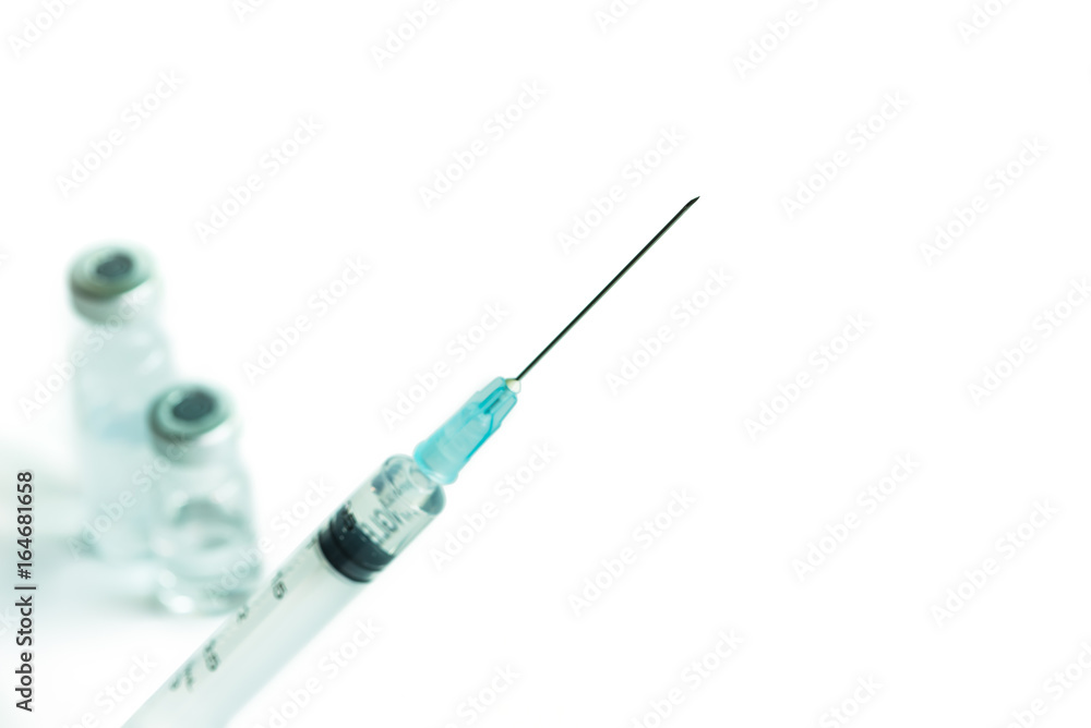 The syringe and needle with vaccine bottle isolated on white background The syringe and needle with vaccine bottle isolated on white background