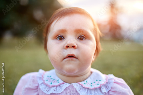 Sweet Beautiful little girl outdoors looking to the camera. Joyful, Happy, Excited. Closeup Portrait © Aleksey