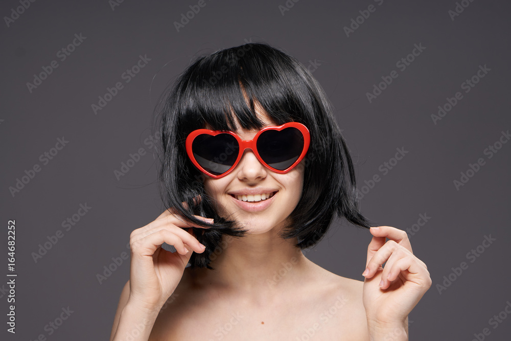 Young beautiful woman on a black background in sunglasses, portrait Young beautiful woman on a black background in sunglasses, portrait