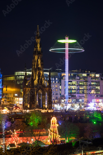 Christmas lights in Edinburgh's Princess Street Gardens with the Sir Walter Scott Monument. Scotland, UK