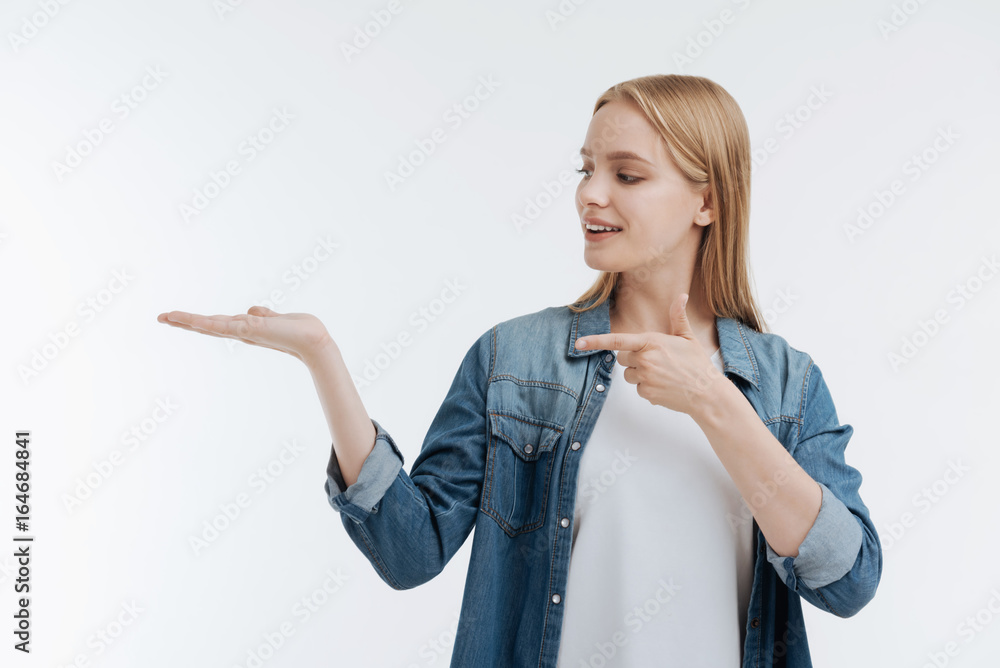Positive delighted blonde female standing isolated on white background Positive delighted blonde female standing isolated on white background